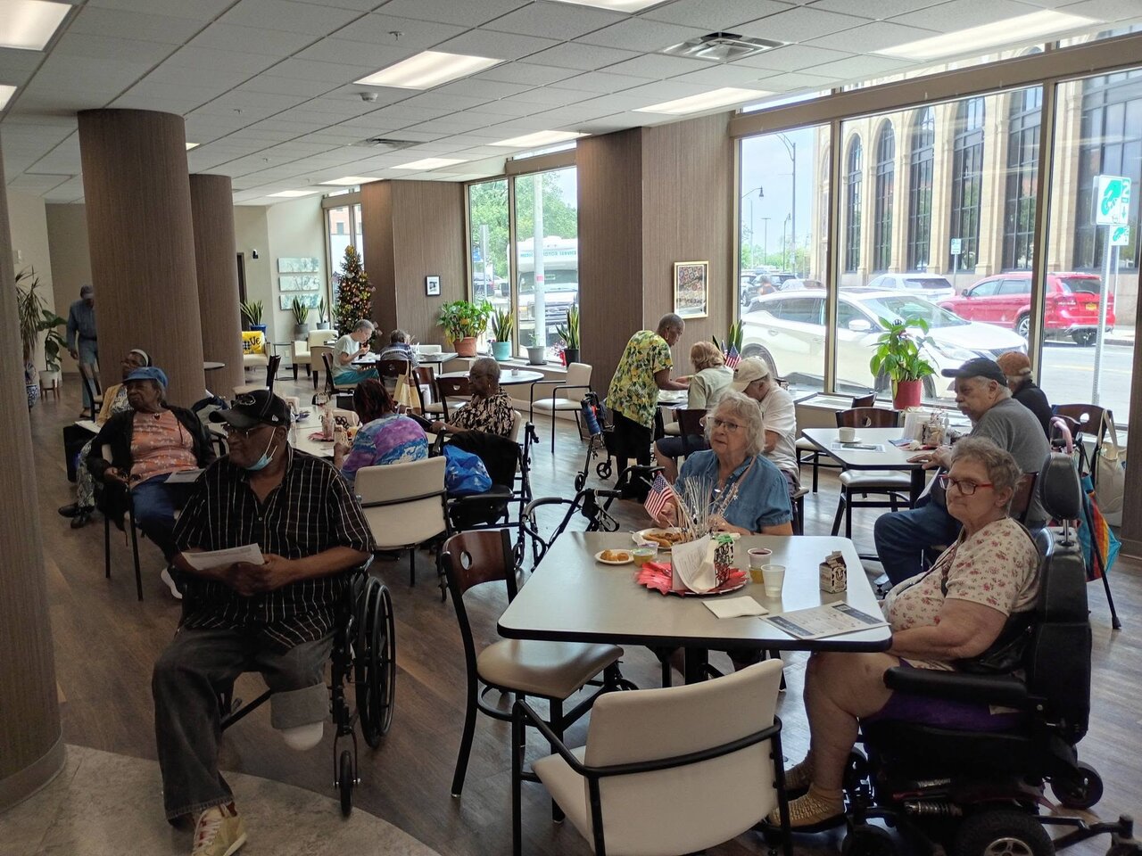 Older adults seated at an AI Fraud Awareness presentation hosted by the StopAiFraud Foundation at Lifespan Walk Café in Rochester, New York.